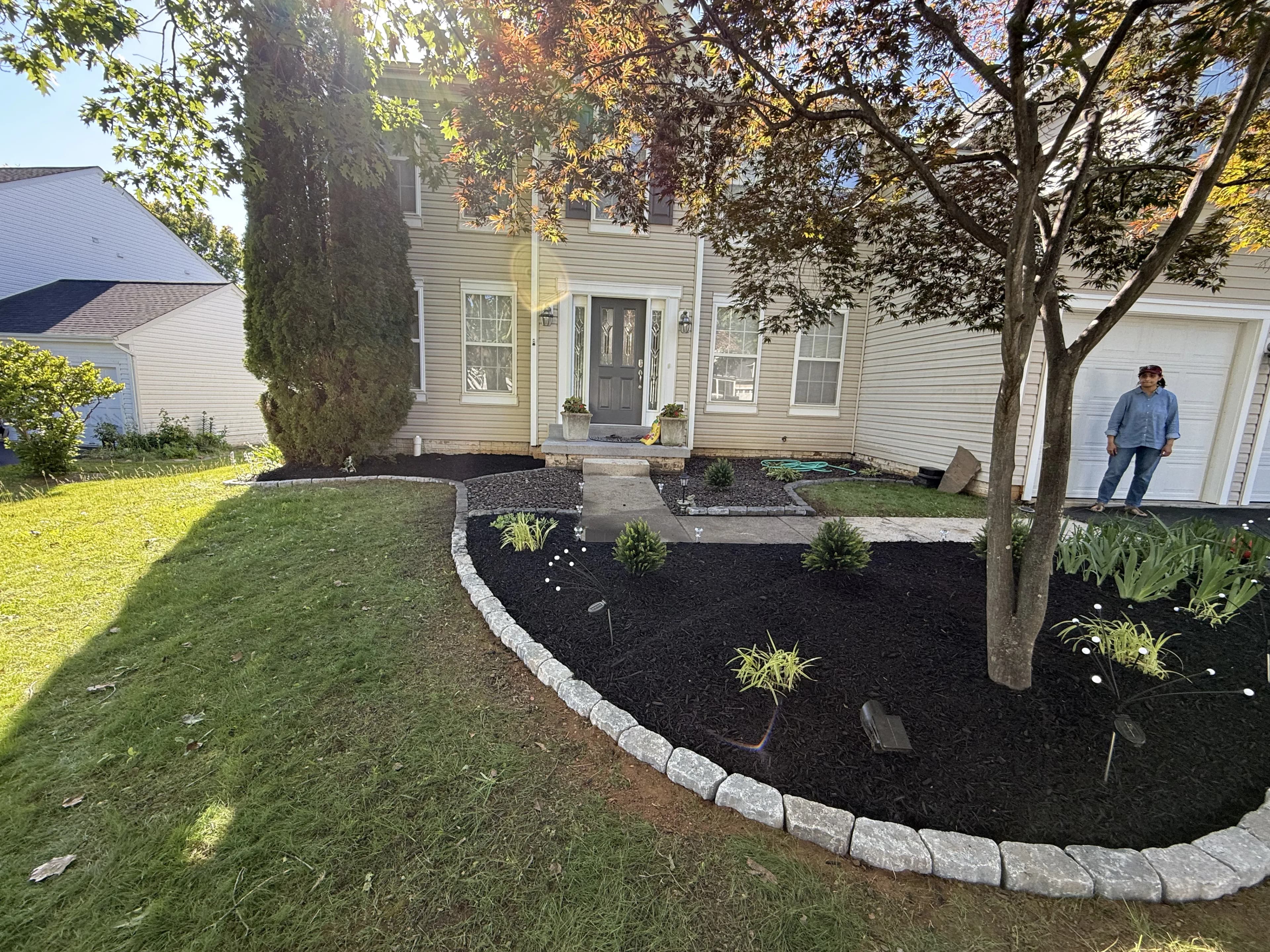 Custom landscape design with pergola and seating area